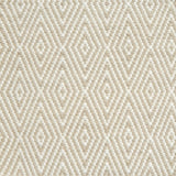 Flatwoven rug detail with a cream and taupe diamond pattern.
