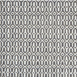 A rug with an overall geometric pattern in dark blue grey and ivory.