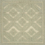 Textured green rug with a subtle raised geometric pattern
