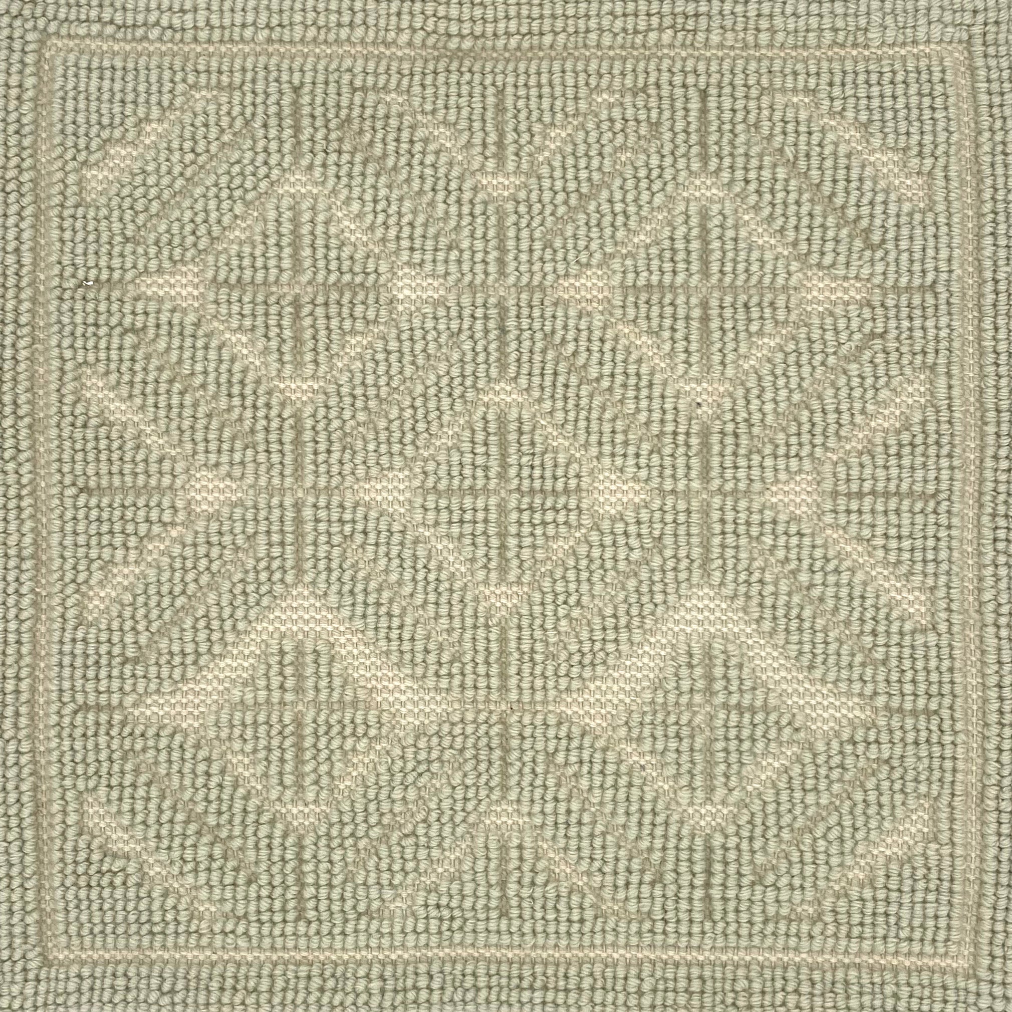 Textured green rug with a subtle raised geometric pattern