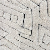 Handknotted Moroccan style rug with a geometric ivory pattern.