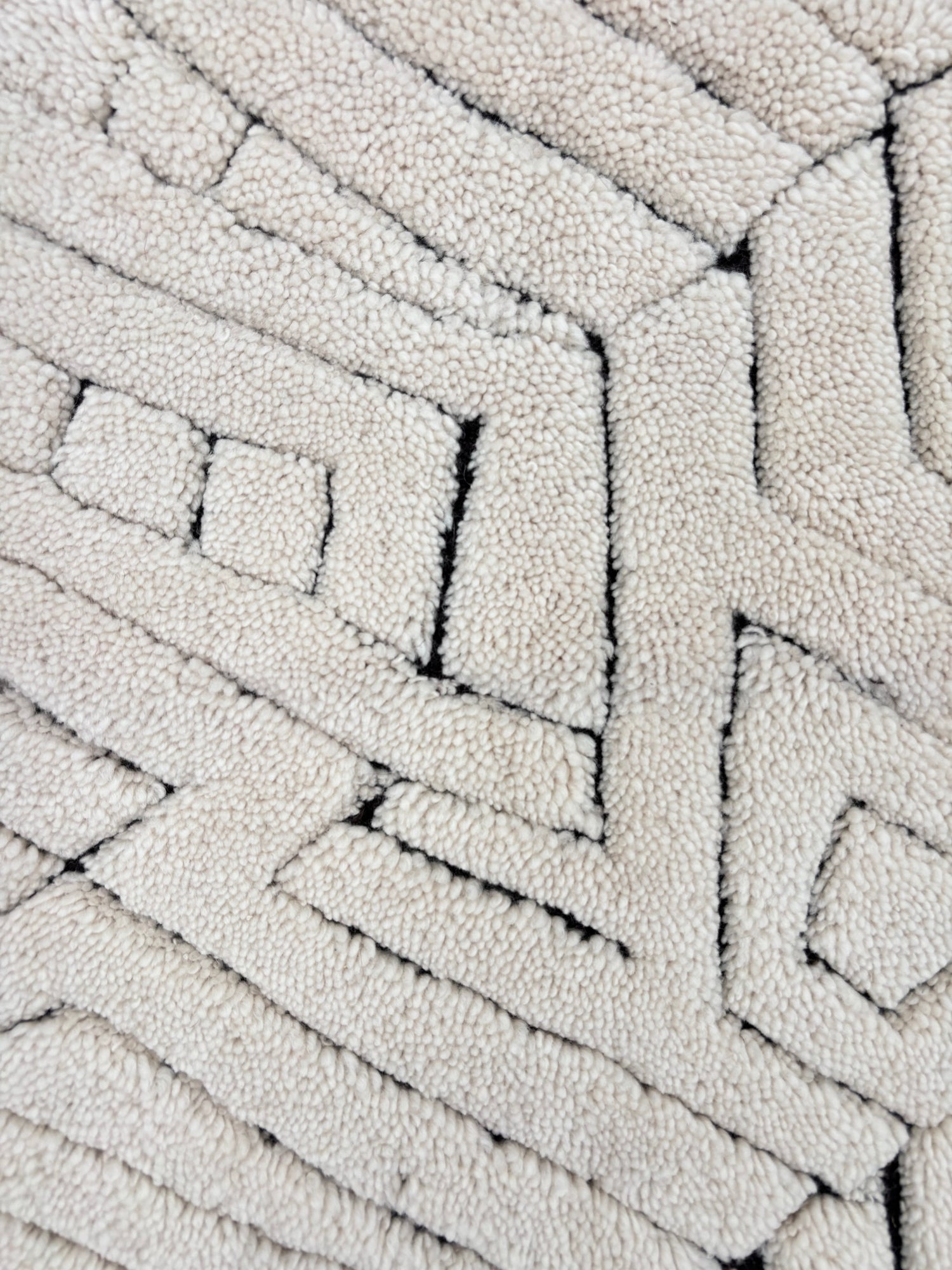 Handknotted Moroccan style rug with a geometric ivory pattern.