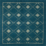 Handmade rug with classic diamond lattice design in teal with cream accents. 