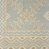 Patterned rug with geometric design on a light blue background