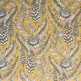 Detail of fabric in a dense floral print in black and white on a yellow field.