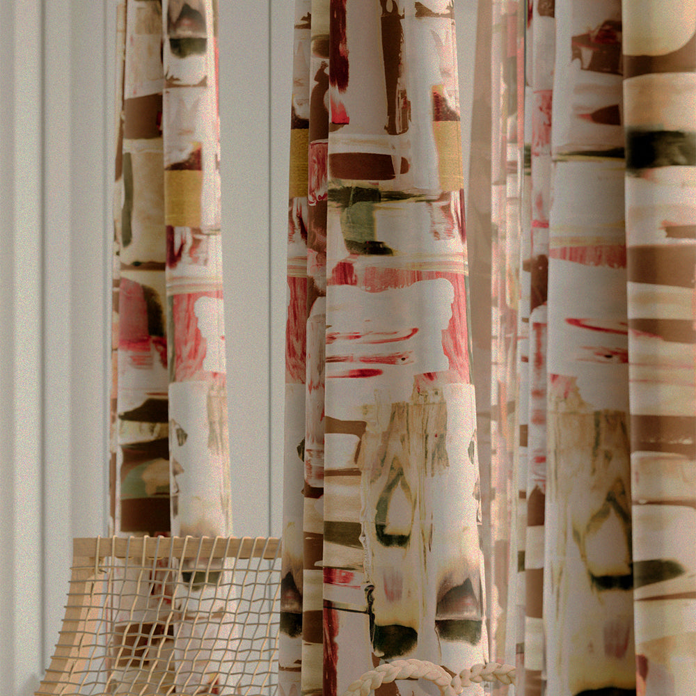 Close-up of a row of curtains in an abstract layered paint blotch print in shades of olive, cream and pink.