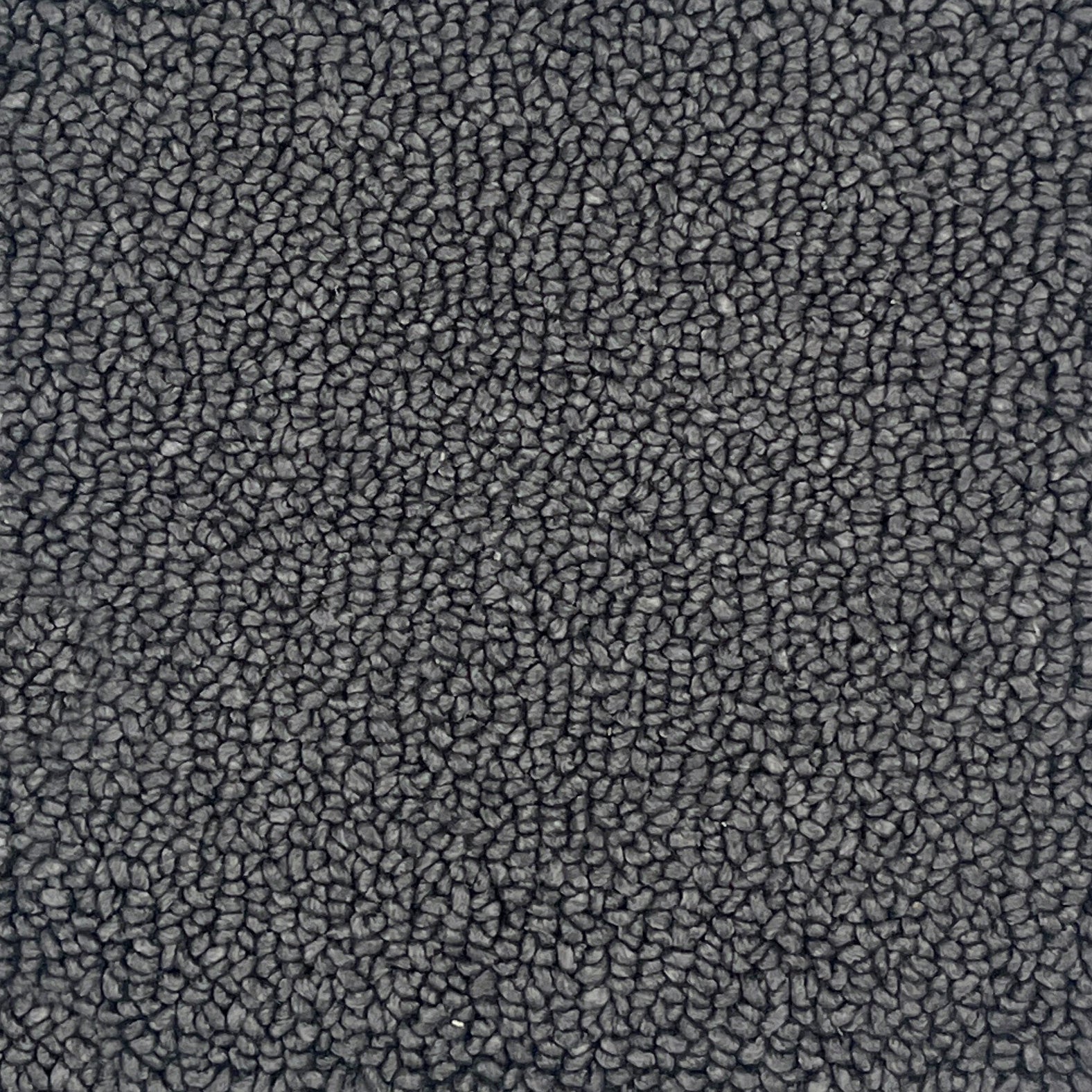 A close-up texture shot of a dark gray loop-pile handtufted rug, showing the dense, pebbled surface pattern.