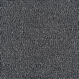 A close-up texture shot of a dark gray loop-pile handtufted rug, showing the dense, pebbled surface pattern.