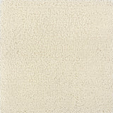 A close-up texture shot of a handtufted rug, showing the cut pile texture in a solid cream color.