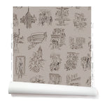 Partially unrolled wallpaper with black hand-drawn illustrations of New York City landmarks on a tan background.