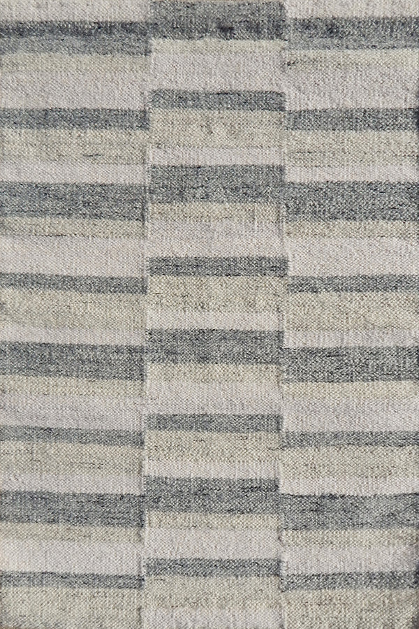 Flatweave rug in a broken stripe in grey, cream and taupe. 
