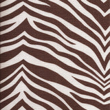 Detail of fabric in a zebra print in brown on a white field.