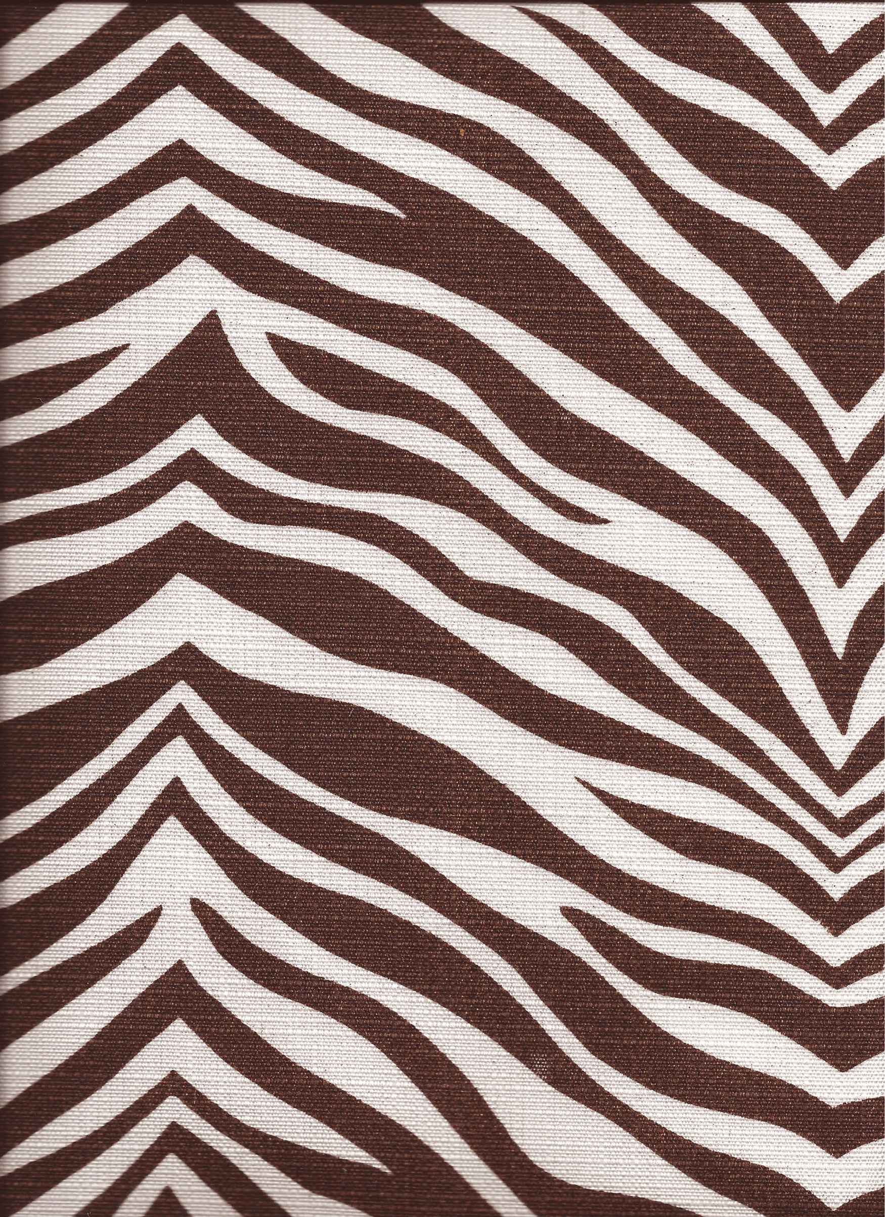 Detail of fabric in a zebra print in brown on a white field.