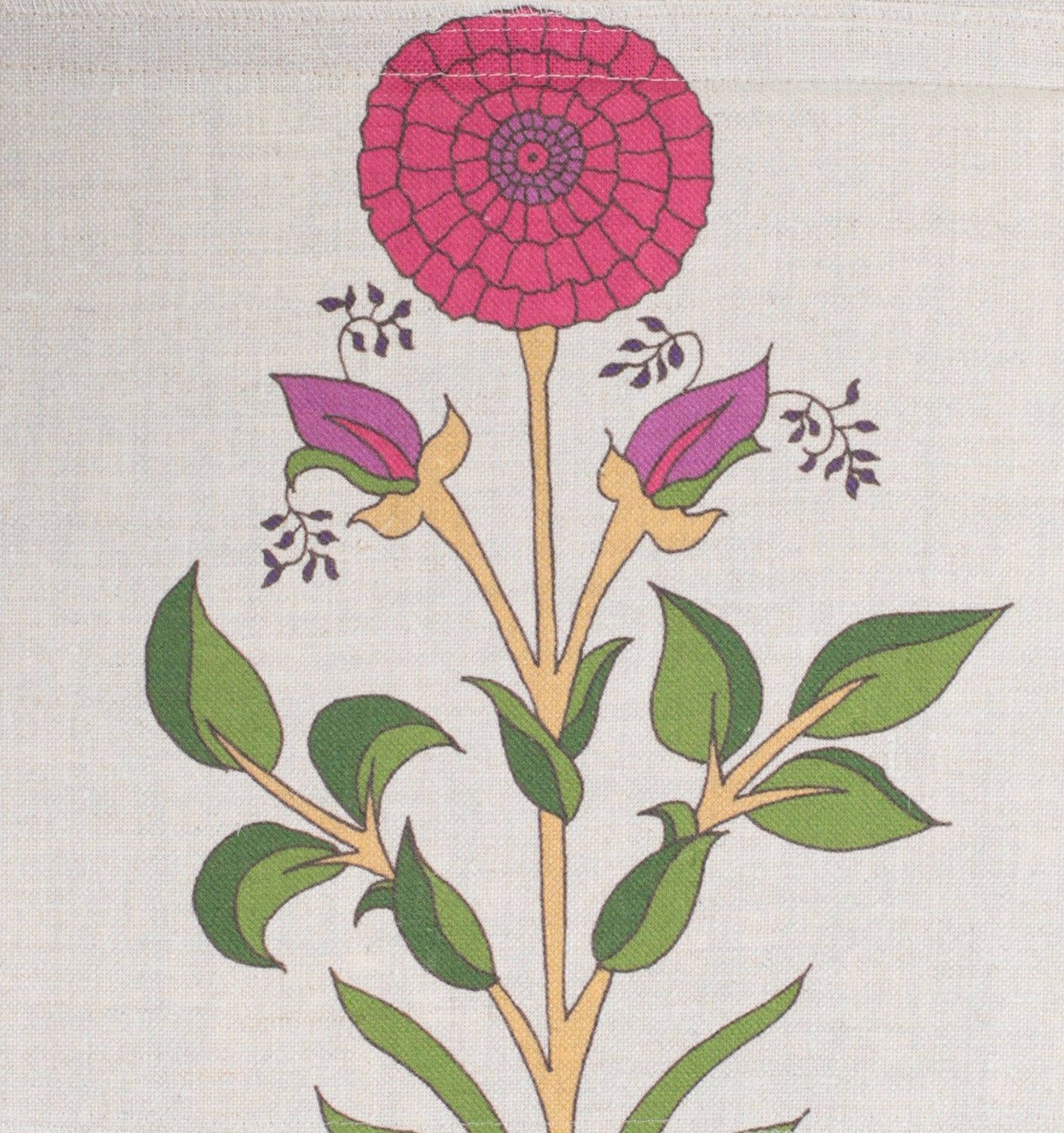 Detail of fabric in a large-scale marigold print in red, purple and green on a cream field.