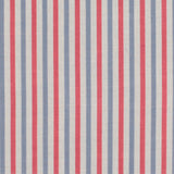 Detail of fabric in a small-scale stripe print in red and blue on a cream field.