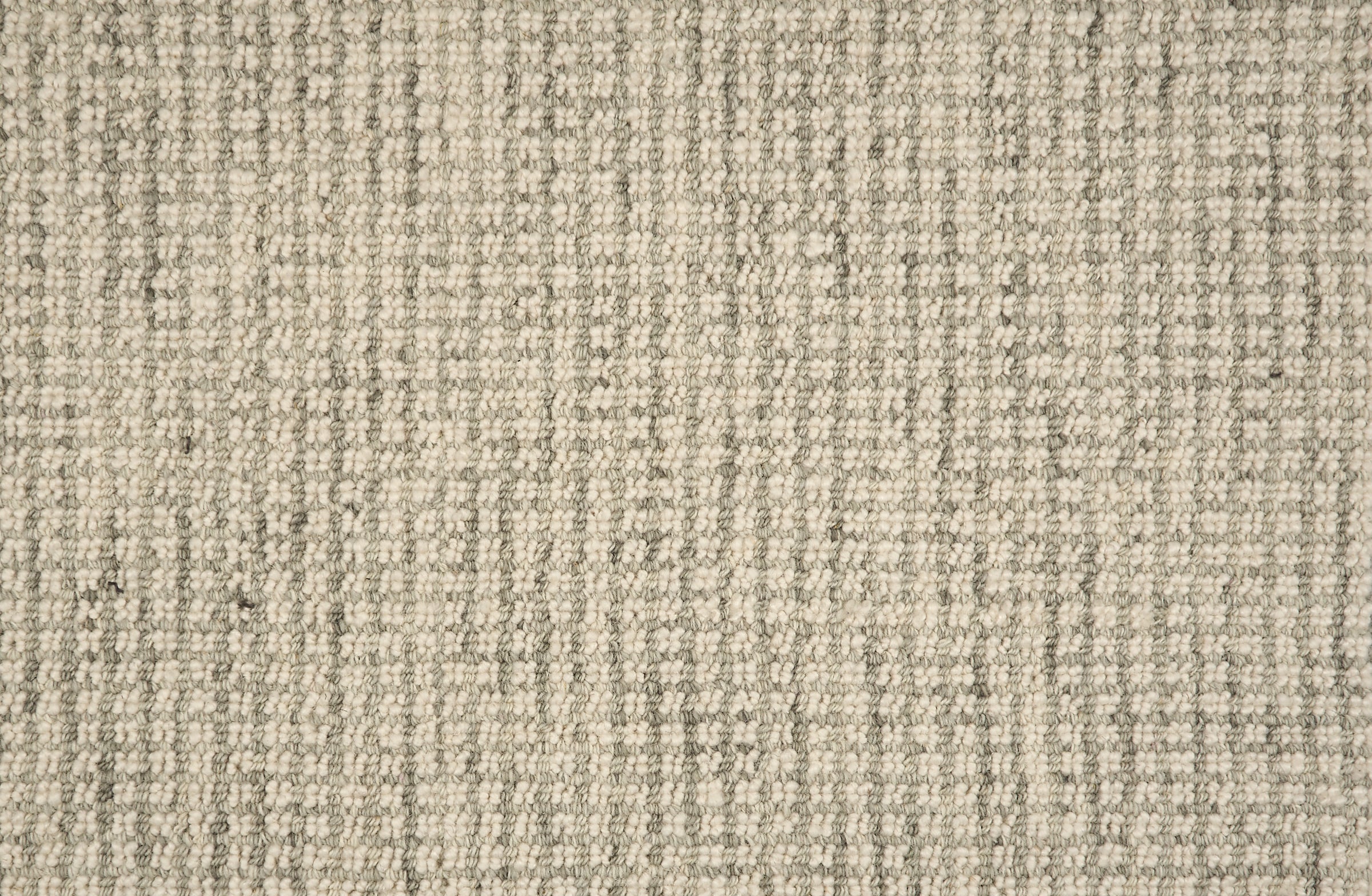 Broadloom carpet in a textural checkered pattern in ivory and grey.