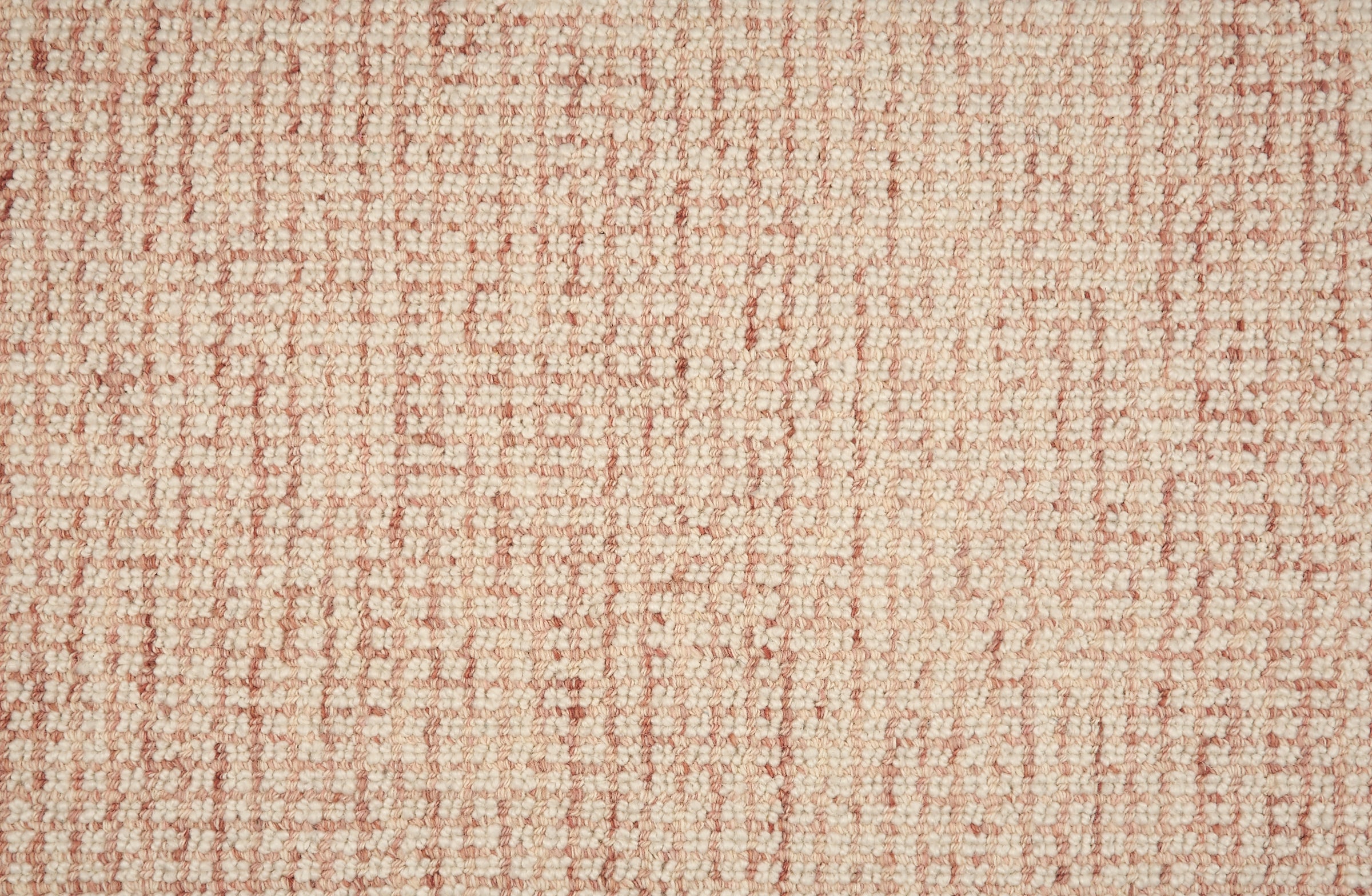Broadloom carpet in a textural checkered pattern in ivory and pink.