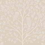 Detail of wallpaper in a repeating owl and tree print in white on a cream field.