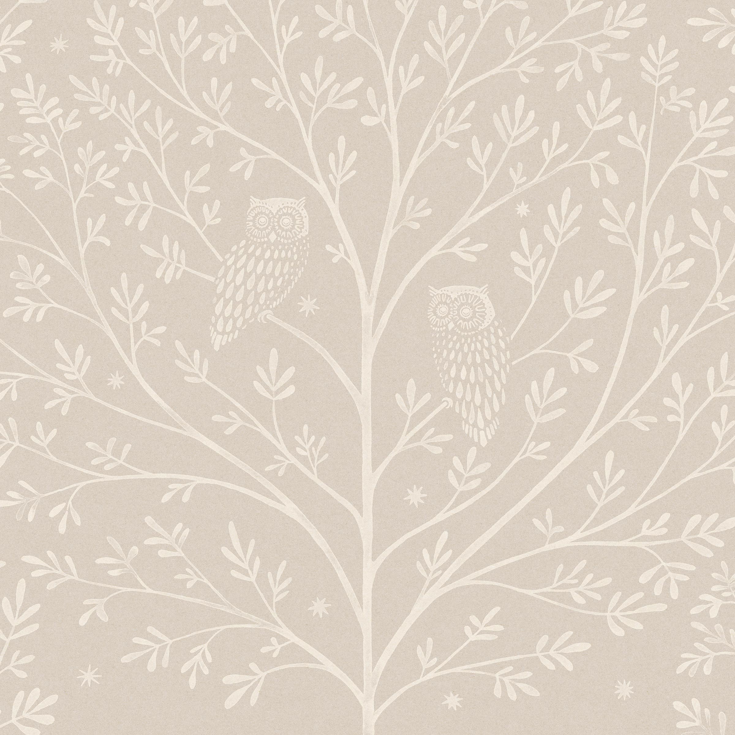 Detail of wallpaper in a repeating owl and tree print in white on a cream field.