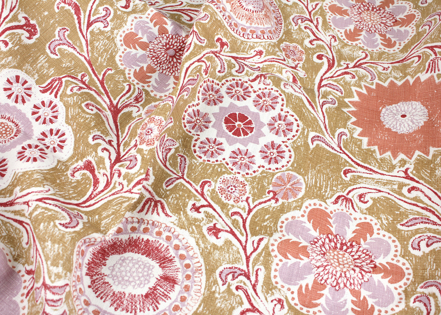 Draped printed linen in a handdrawn playful floral design in coral, lilac and red against a tan field. 