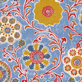 Printed linen in a handdrawn playful floral design in red, yellow, green and blue on a light blue field.