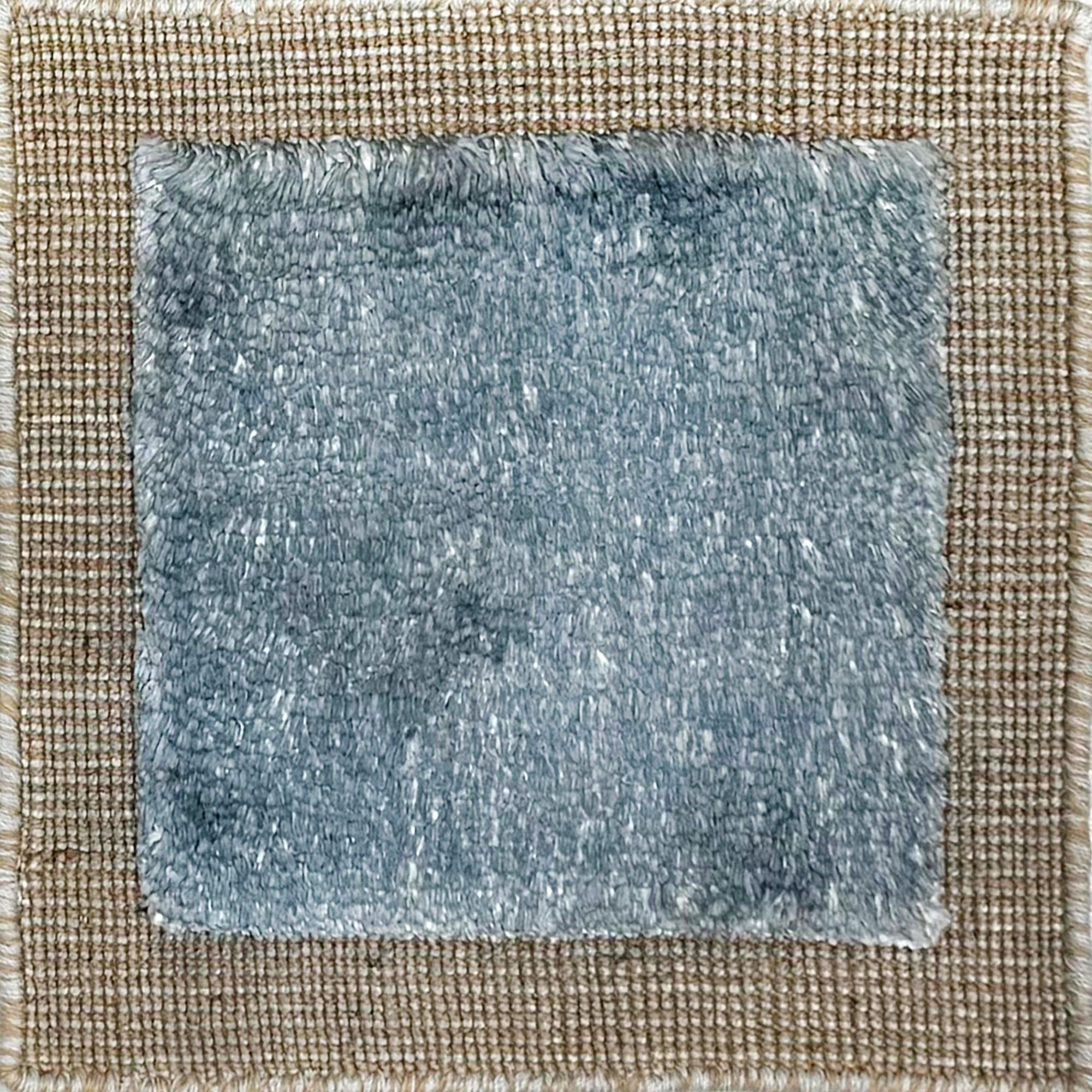 Handloomed rug with neutral border and raised cut pile shag field in aqua blue.