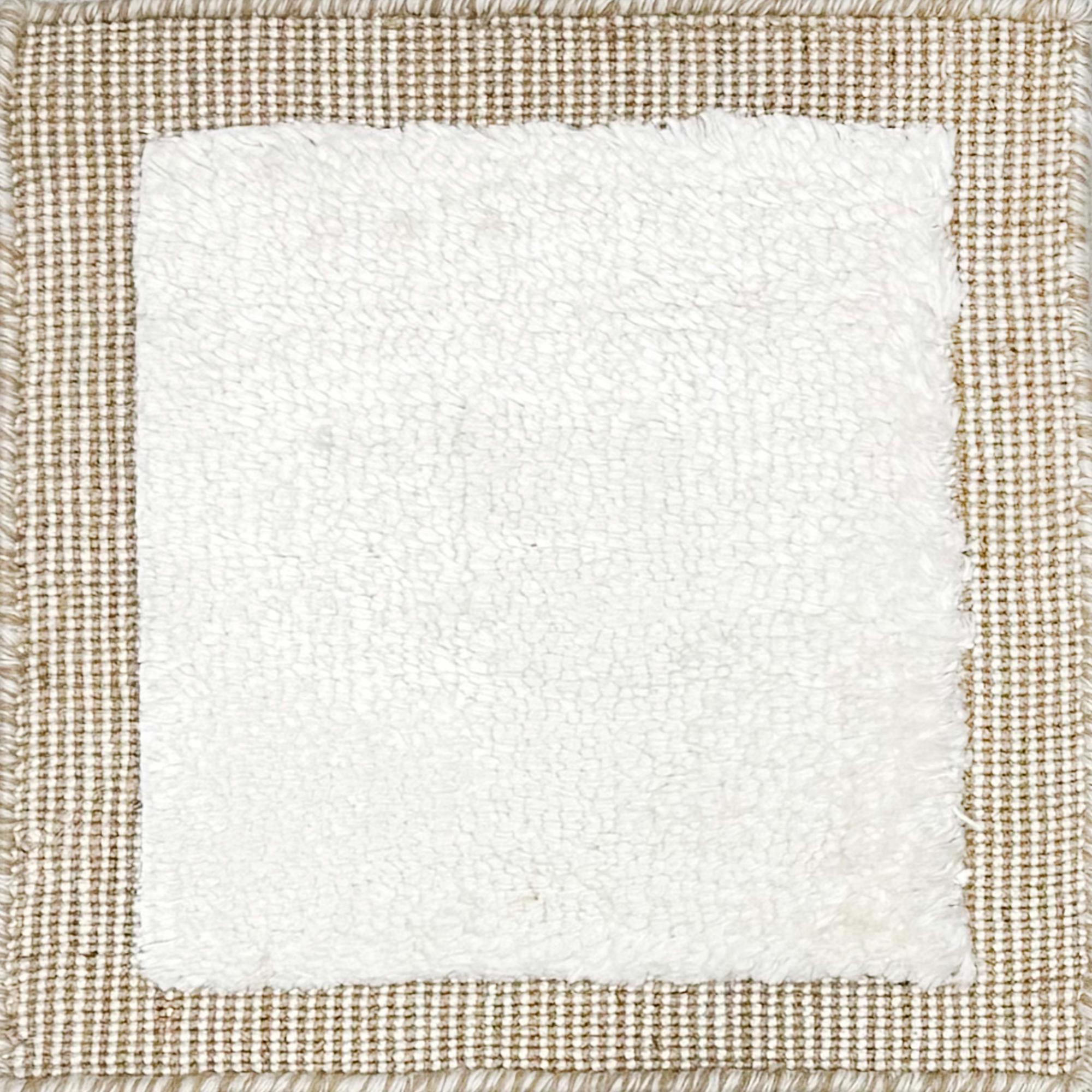 Handloomed rug with neutral border and raised cut pile shag field in white.