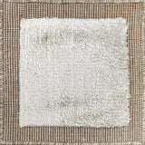 Handloomed rug with neutral border and raised cut pile shag field in grey. 