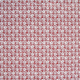 Detail of fabric in a floral grid print in white and maroon on a red field.