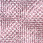 Detail of fabric in a floral grid print in white and red on a pink field.