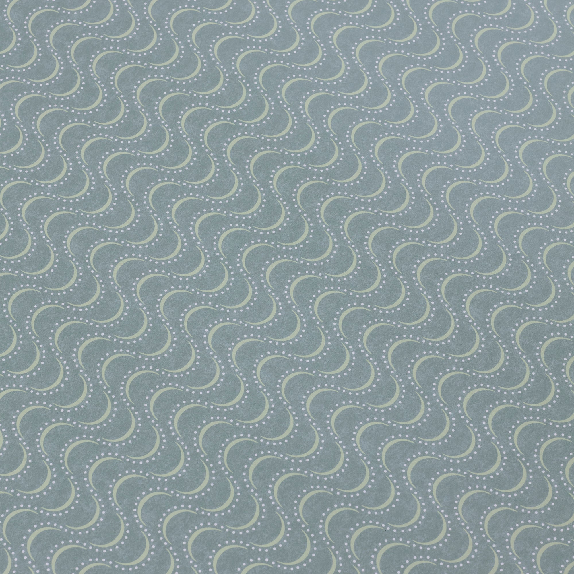 Detail of a wallpaper panel in an undulating stripe pattern in light green and blue on a turquoise field.