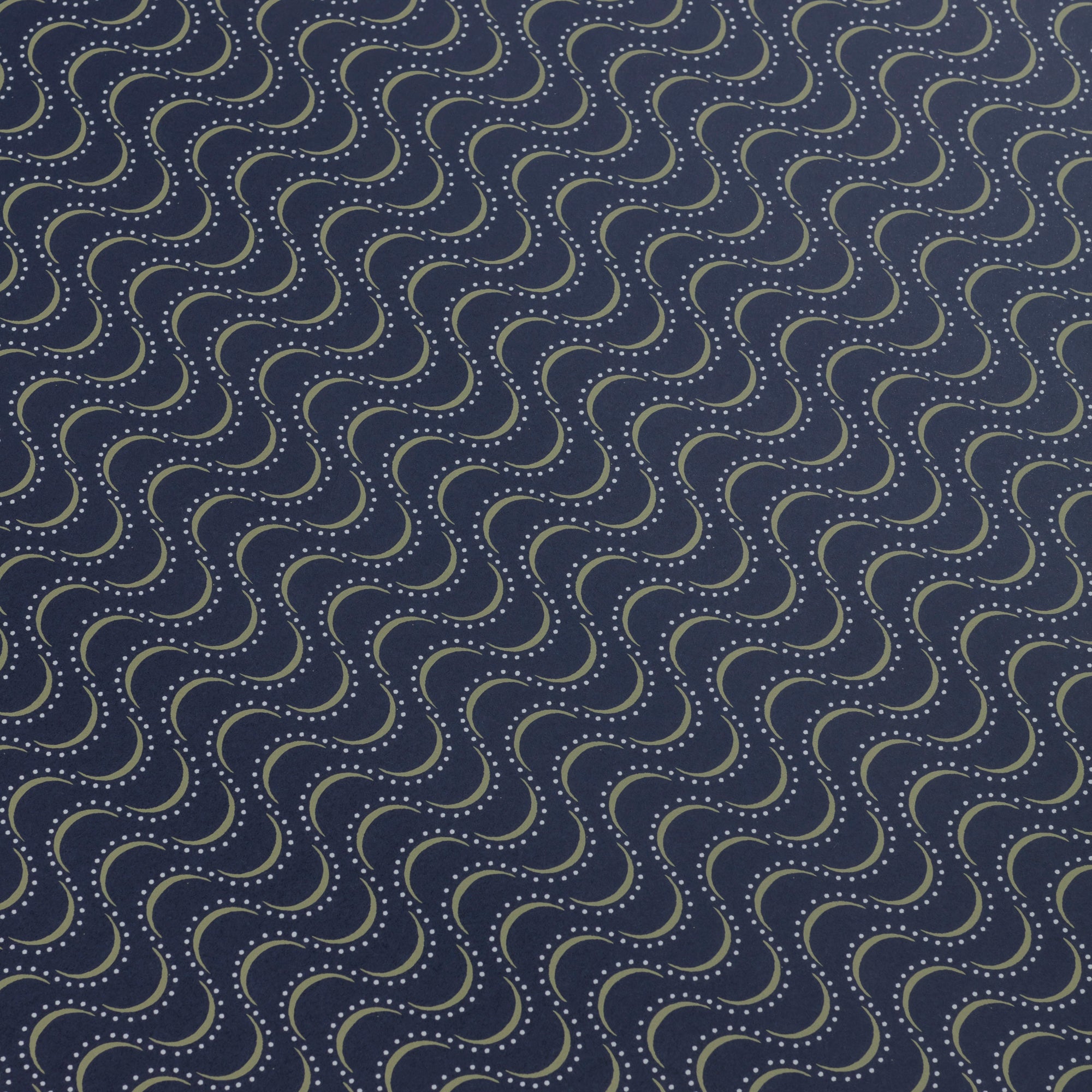 Detail of a wallpaper panel in an undulating stripe pattern in white and mustard on a dark navy field.