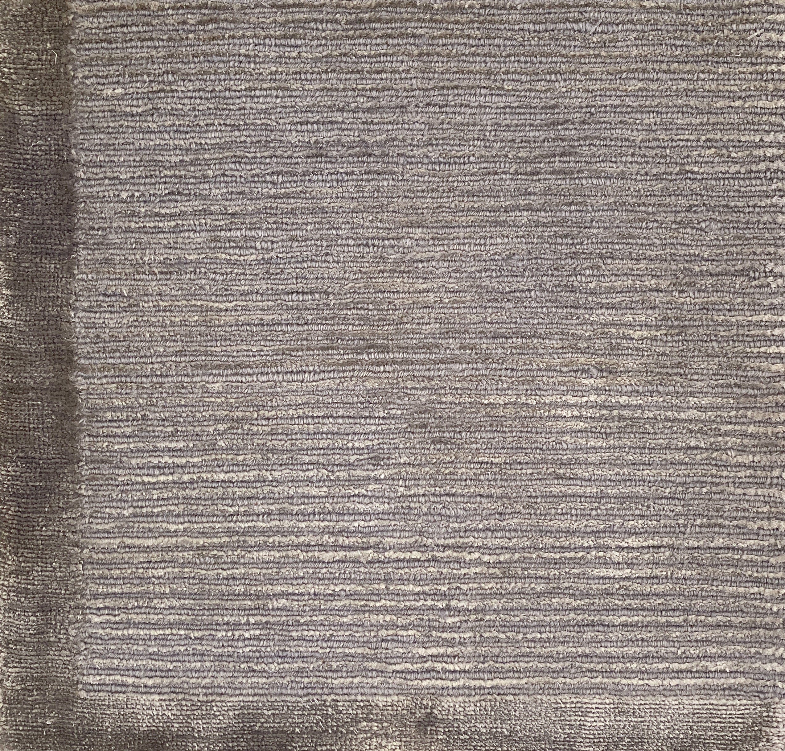 Handknotted rug with border and subtle rib design in grey