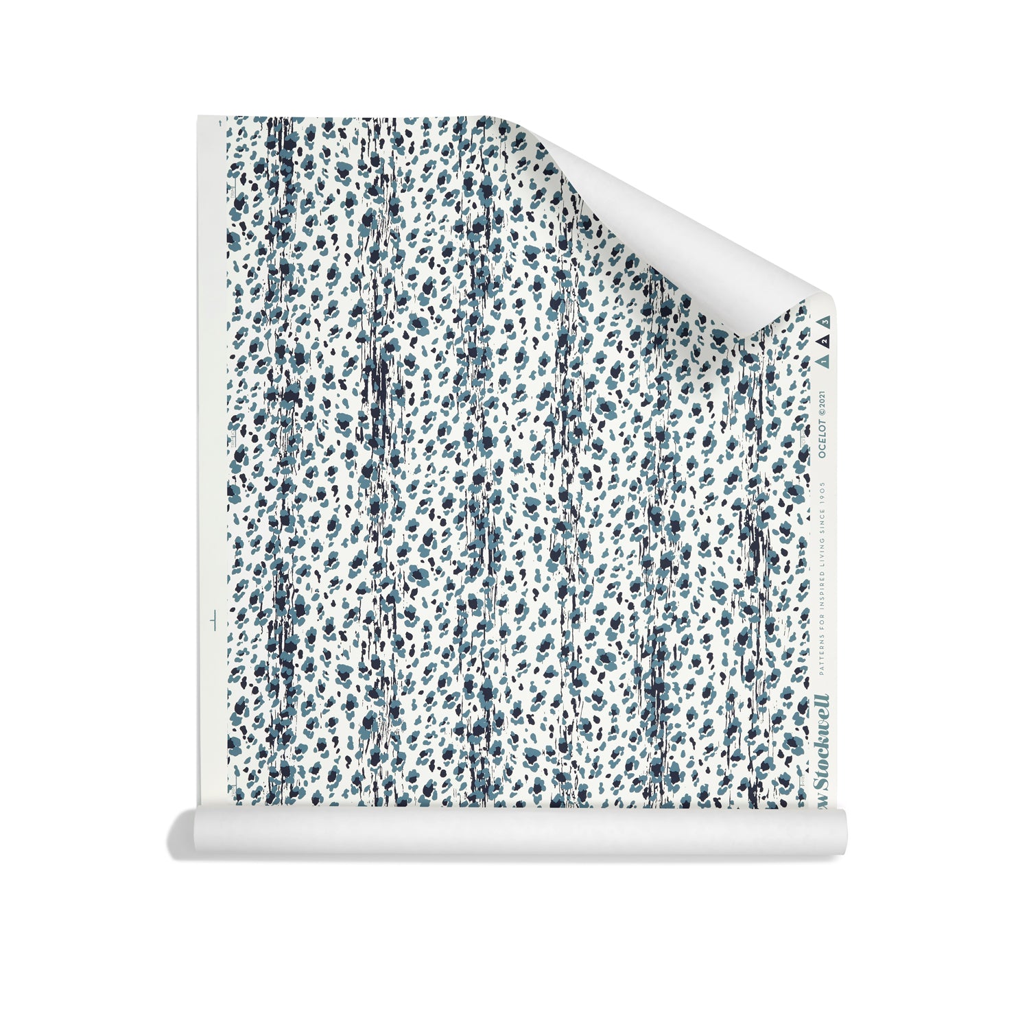Roll of wallpaper with small scale painterly animal print in light and dark blue on white.