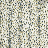 Close up of wallpaper with small scale painterly animal print in tan and dark green on white. 