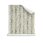 Roll of wallpaper with small scale painterly animal print in tan and dark green on white. 