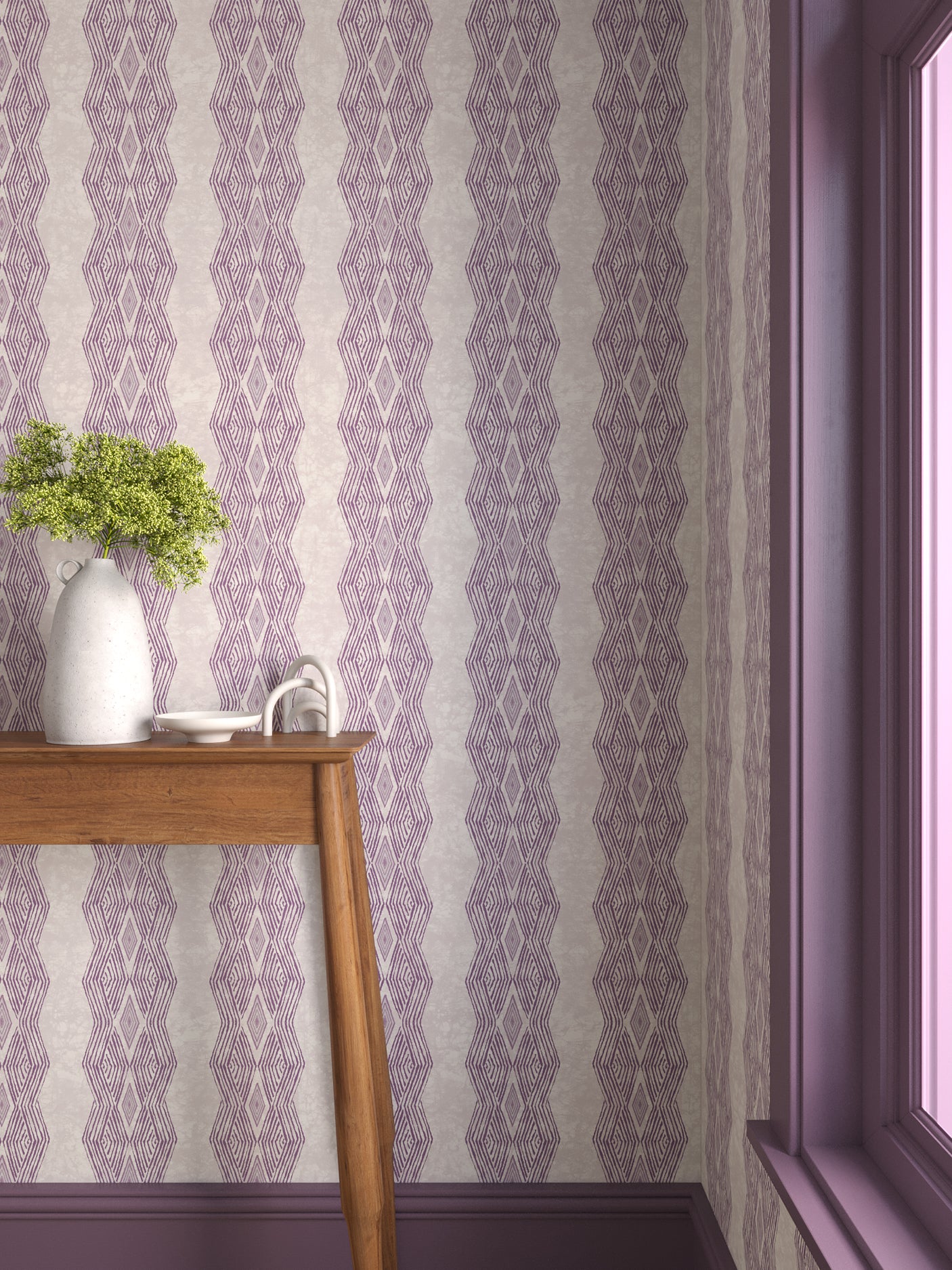 Interior with purple geometric wallpaper and matching trim with a wooden console table with white ceramic vases with flowers. 