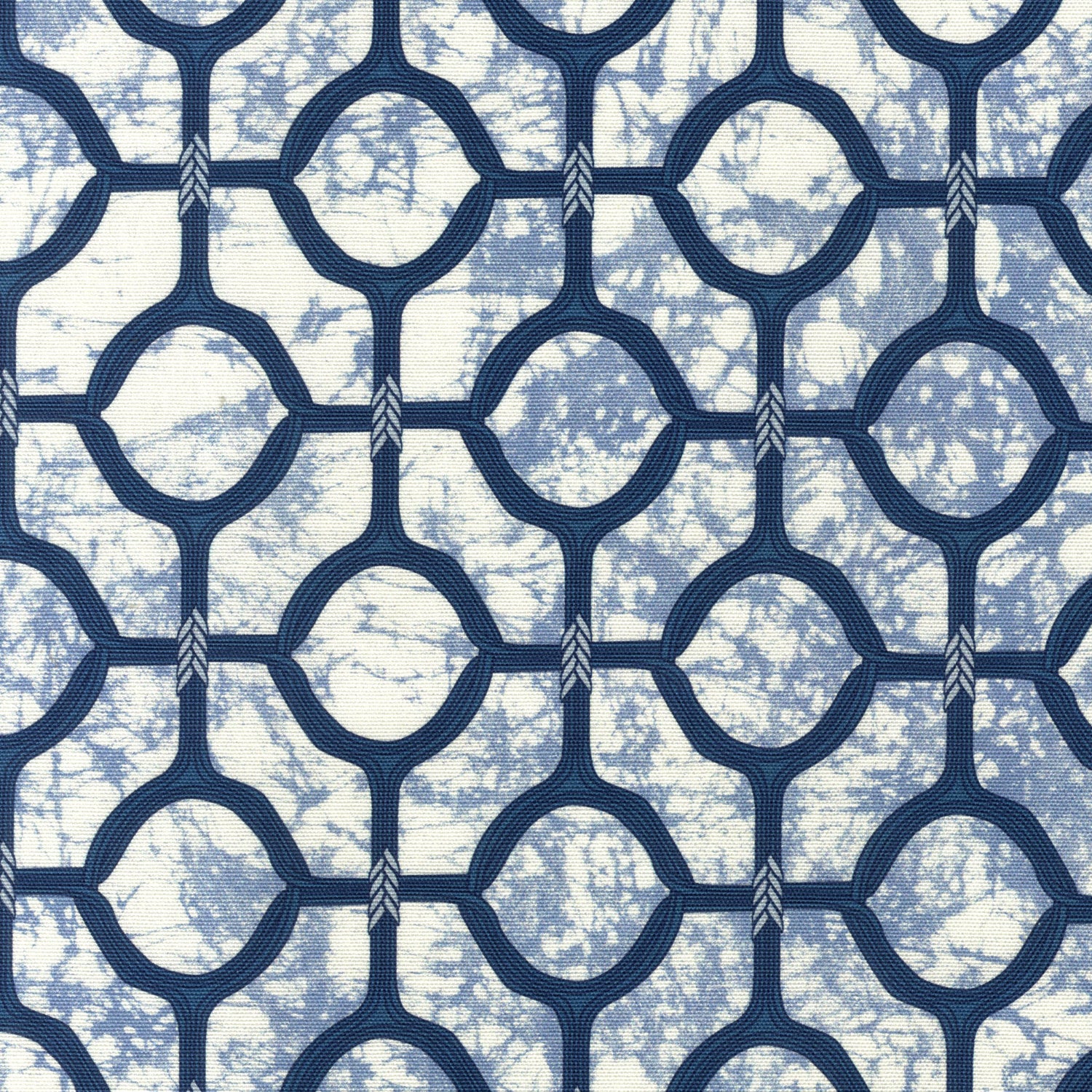 Detail of fabric in a rounded lattice print in navy on a mottled blue field.