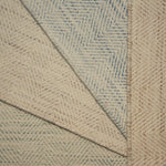 Stack of four broadloom carpet samples with herringbone pattern in soft pastel colors. 