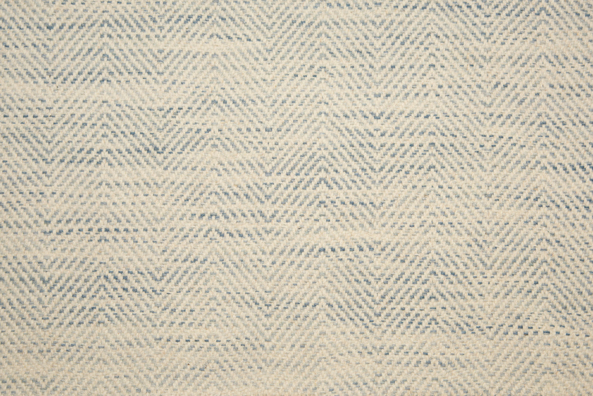 Broadloom carpet with herringbone weave in cream blended with light blue. 