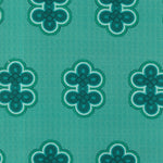 Detail of fabric in a repeating curvilinear knot print in blue and turquoise on a turquoise field.