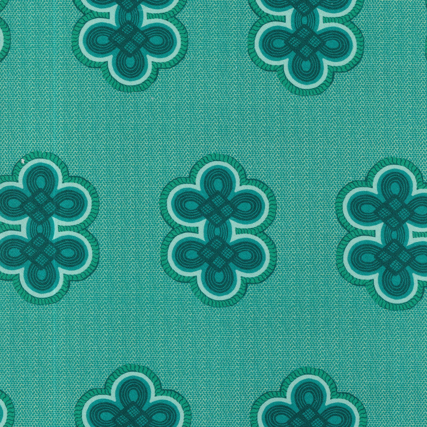 Detail of fabric in a repeating curvilinear knot print in blue and turquoise on a turquoise field.