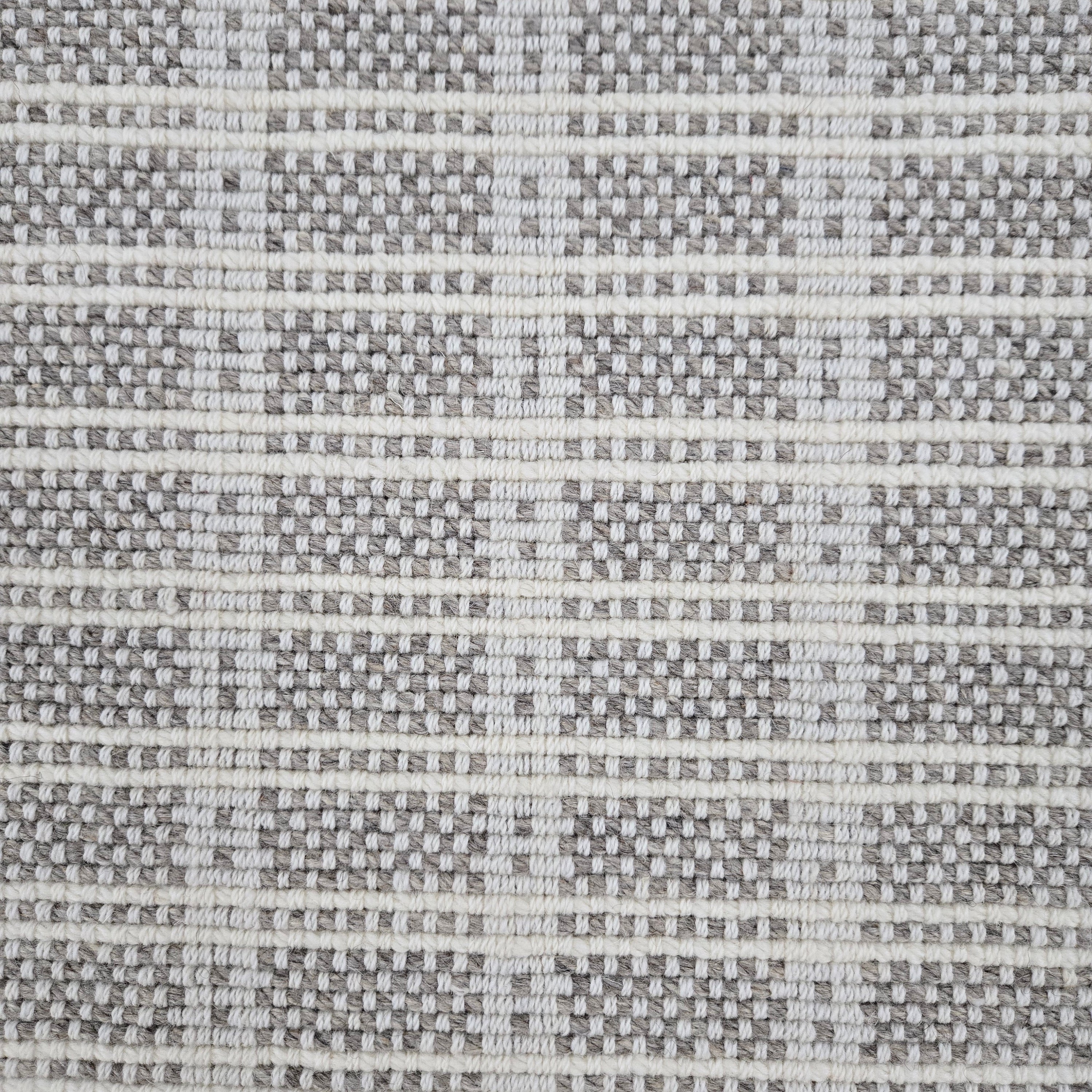 Broadloom carpet in slim plaid pattern in cream and grey.
