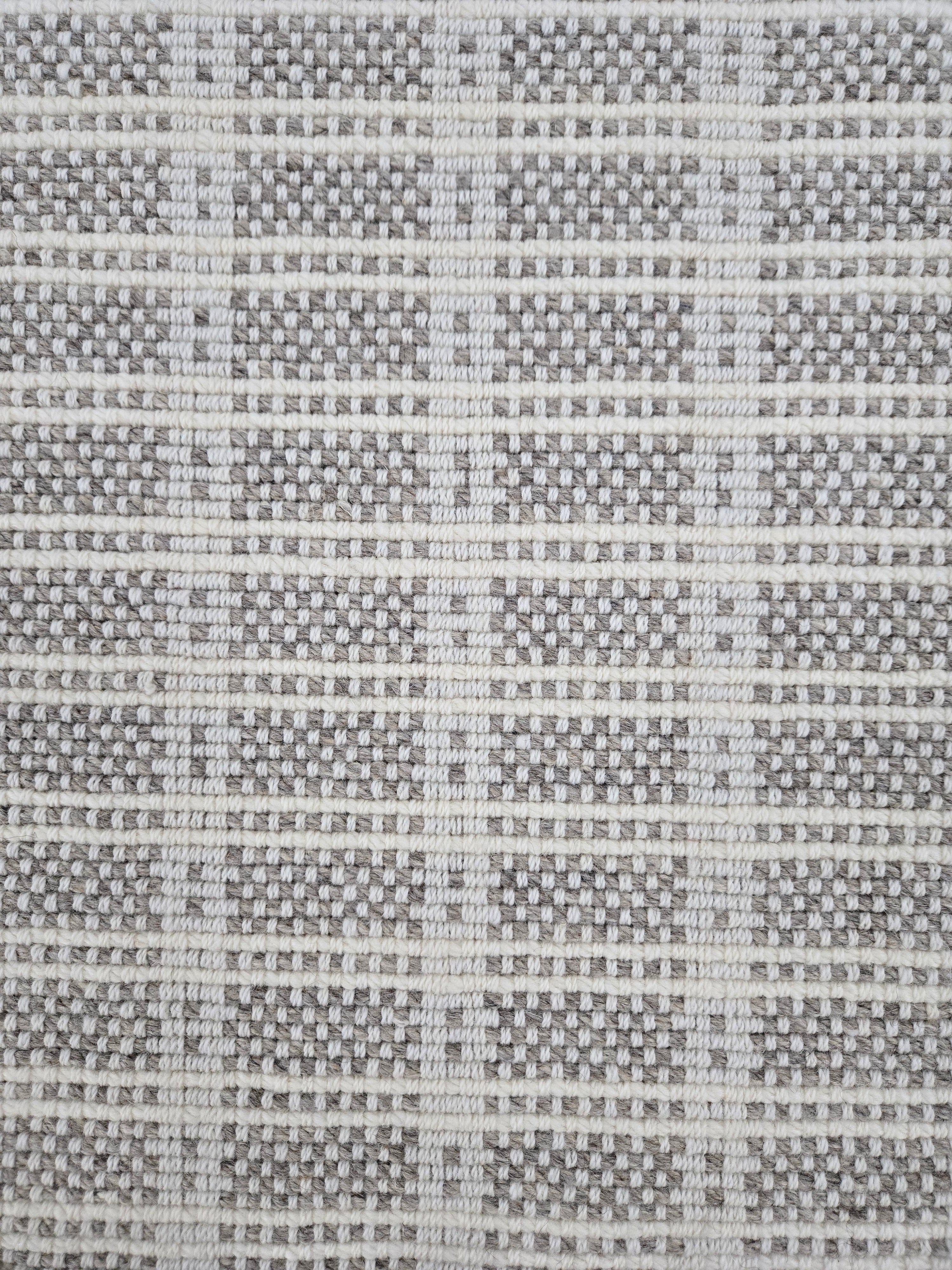Broadloom carpet in slim plaid pattern in cream and grey.