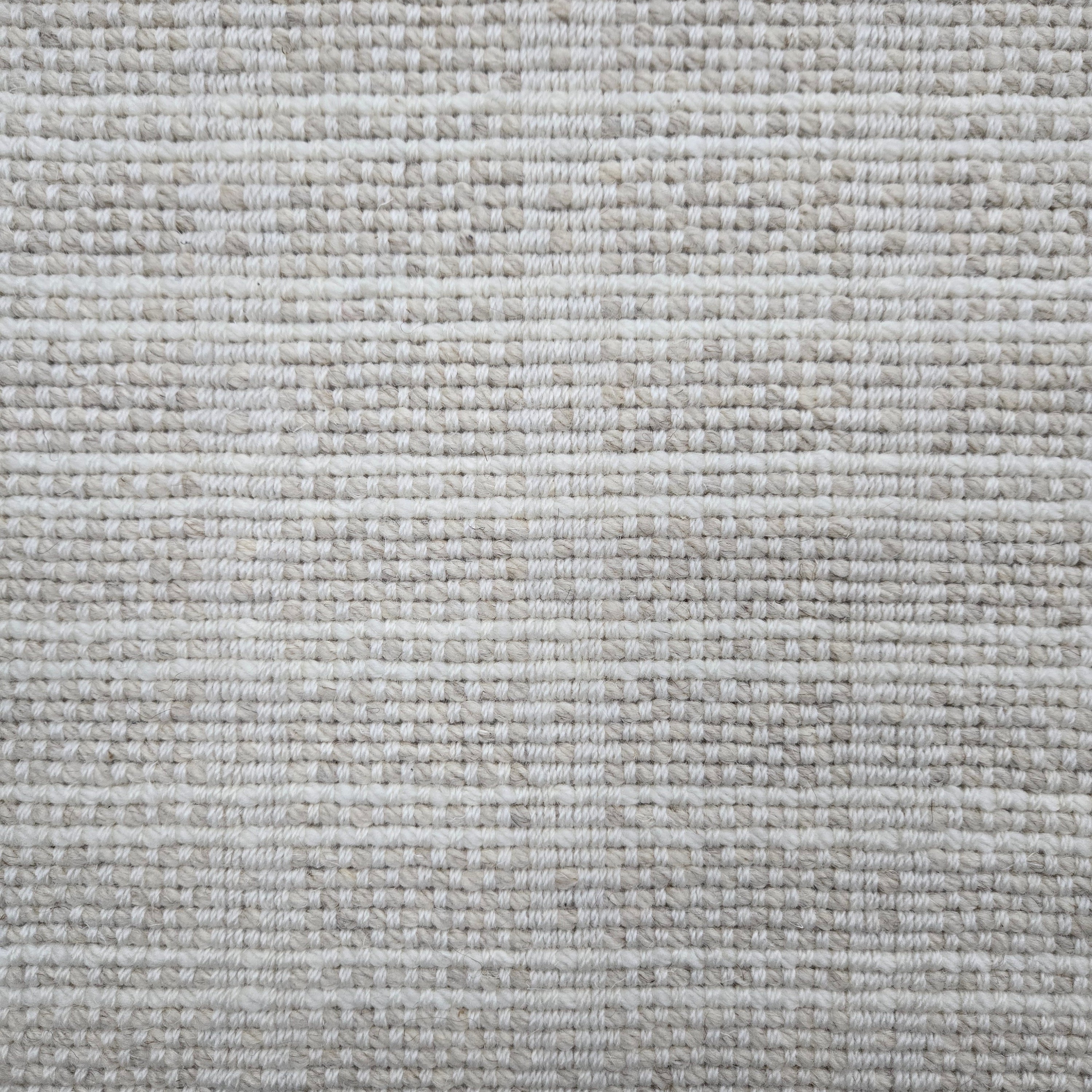 Broadloom carpet in slim plaid pattern in cream and beige.