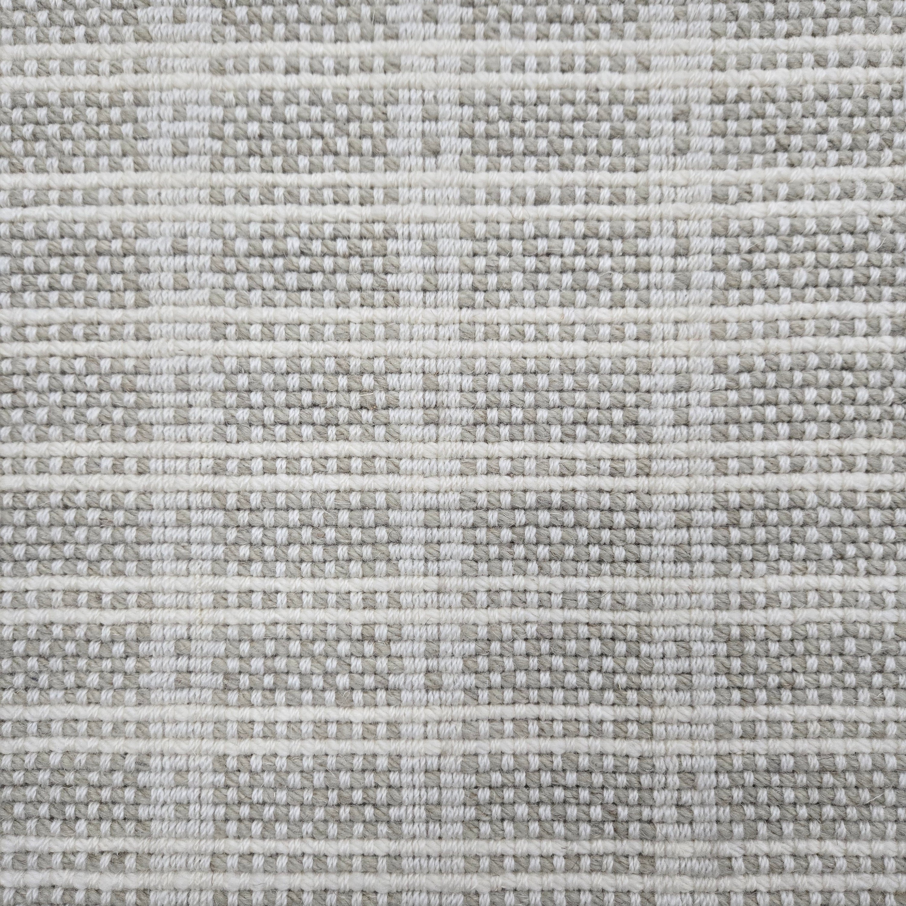 Broadloom carpet in slim plaid pattern in cream and ecru.
