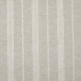 Detail of fabric in a small-scale botanical stripe print in cream on a tan field.
