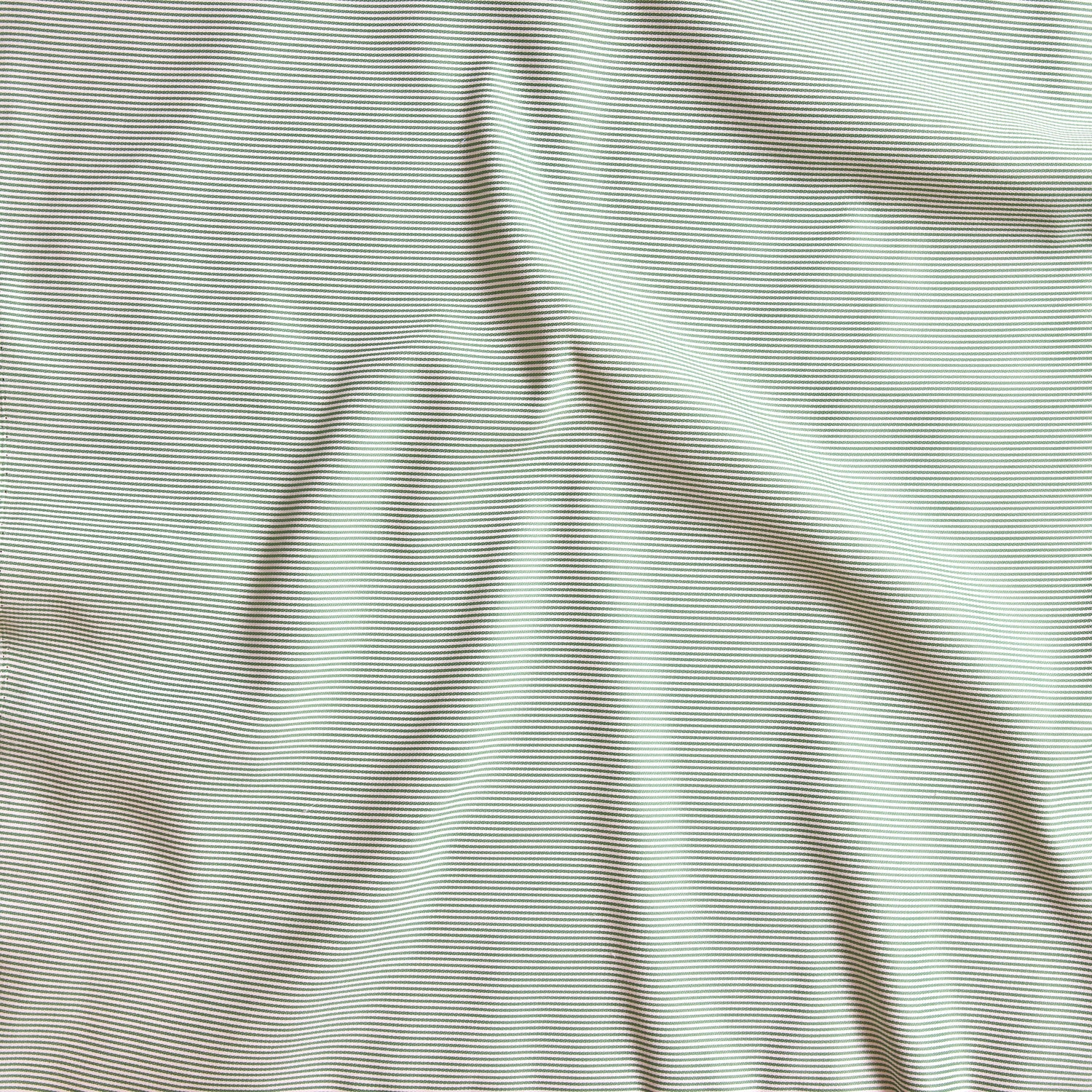 Close up of gently draped pin striped woven Indoor-Outdoor fabric in white and green