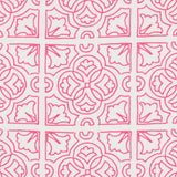 Detail of fabric in a damask lattice print in magenta on a white field.