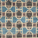 Patterned rug with geometric design in blue, brown, and beige colors.